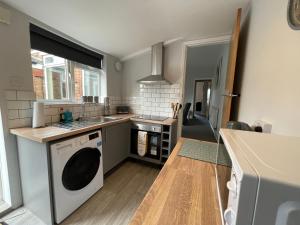 a kitchen with a washer and dryer in it at Windmill View Apartments in Lincolnshire