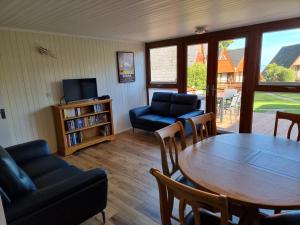 a living room with a table and chairs and a television at Chalet Brightstone Kingsdown Cliffs location with indoor pool, tennis court, mini-golf short walk to beach and 3 great local pubs in Kingsdown