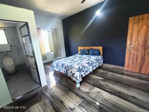 a bedroom with a bed and a large mirror at Basant - Madhu in Alibaug