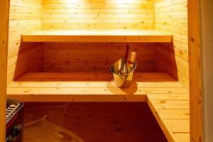 a wooden sauna with a bucket in the middle at Riad SofYan & Spa in Marrakesh