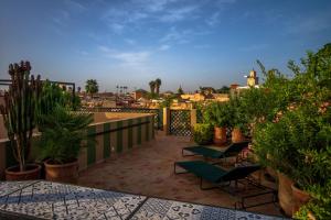 a patio with chairs and plants on a balcony at Riad SofYan & Spa in Marrakesh