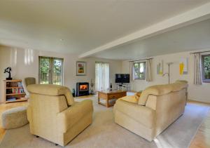a living room with two chairs and a couch at Shuttleworth Lodge in Thursford