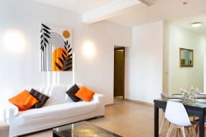 a living room with a white couch and a table at Roulette Your St Julians Base for a Fun Getaway in Paceville