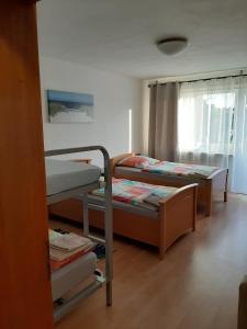 a room with two bunk beds and a window at Ferienwohnung Julechka in Bremerhaven +8 photos