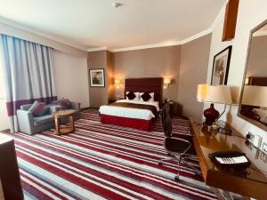 Een bed of bedden in een kamer bij Wonder Palace Hotel Qatar