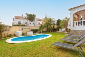 a backyard with a swimming pool and a house at Casa Guadalmar in Málaga