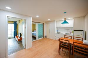 a kitchen and dining room with a table and chairs at Mega Resort in Jeju