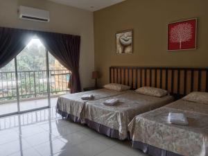 a bedroom with two beds and a large window at Gold Coast Morib Resort in Banting +46 photos