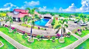 an aerial view of a resort with a swimming pool and palm trees at Avonil Resort Yala in Tissamaharama