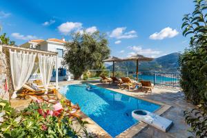 a villa with a swimming pool with a view of the ocean at villa Avaton near Skopelos town in Skopelos Town