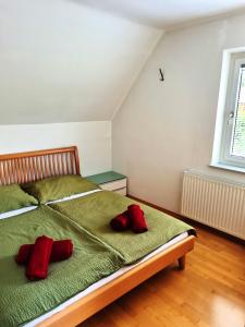 a bedroom with a bed with two red pillows on it at Kreischberg Deluxe with Finnish Sauna in Sankt Lorenzen ob Murau