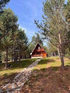 a cabin in the middle of a field with trees at Cozy Forest Hut near Sarajevo in Pale