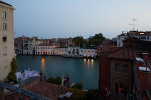 a view of a river in a city with buildings at Hotel Dei Dragomanni in Venice