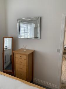 a bedroom with a mirror and a dresser with a dresser at The office at the old Forge 
