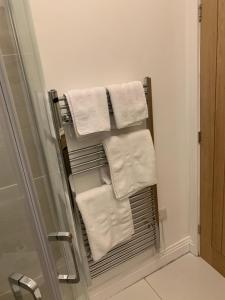 a towel rack in a bathroom with white towels at The office at the old Forge 