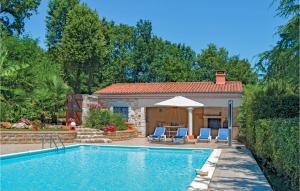 a swimming pool with chairs and a house at Amazing Home In Savignac Les Eglises With Private Swimming Pool, Can Be Inside Or Outside in Savignac-les-Églises