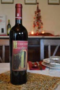 a bottle of wine sitting on top of a table at BeB LE CASE ROSSE in Verucchio