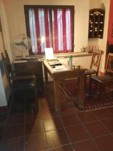 a desk with a lamp and chairs in a room at BeB LE CASE ROSSE in Verucchio