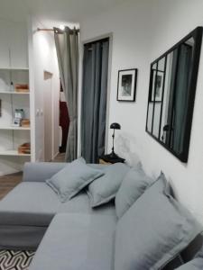 un soggiorno con divano e alcuni specchi di L'Aiglon a Cauterets