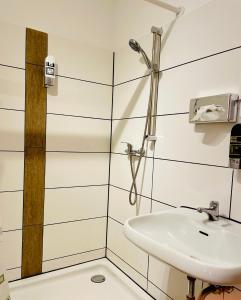 a bathroom with a sink and a shower at Hotel STORY Hamburg in Hamburg