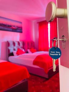 a pink bedroom with a bed with a key at Hotel STORY Hamburg in Hamburg