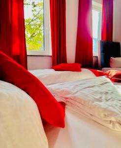 two beds in a room with red curtains at Hotel STORY Hamburg in Hamburg