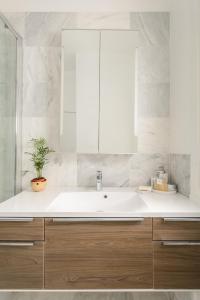 a bathroom with a sink and a mirror at The Grassmarket Apartment in Edinburgh