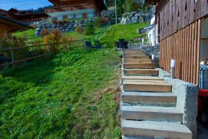 a set of stairs leading up to a building at Serpolet - Studio loft - Sauna in Leysin