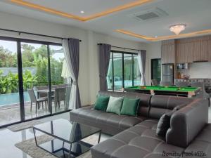 - un salon avec un canapé et un billard dans l'établissement Bonita Pool Villa, à Buriram