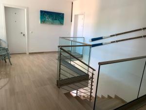 a stairwell in a room with a glass case at Villa Elisabeth in Lignano Sabbiadoro