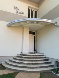 a building with stairs in front of a building at Villa Elisabeth in Lignano Sabbiadoro