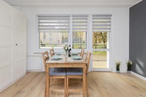 a dining room with a table and chairs and a window at Dedala Apartment 300m to the Beach by Renters in Gdynia