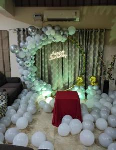 a room with a bunch of white balloons and a table at Private 4-BHK Villa with Swimming Pool, Wifi, BBQ in Chennai