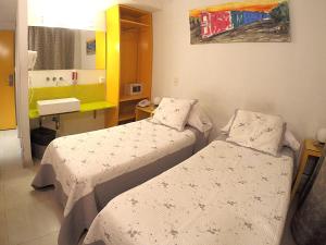 a hospital room with two beds and a sink at America Del Sur Hostel Buenos Aires in Buenos Aires