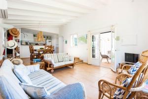 a living room with a couch and chairs at Villa Hércules 115 Binidali in Cap d'en Font