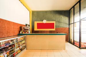 a grocery store with a counter in a store at OYO 91855 Big Hotel Kendari in Kendari