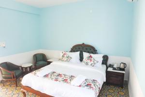 a bedroom with a bed and a desk and chairs at KothiPushkar in Pushkar
