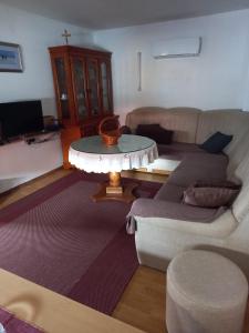 a living room with a couch and a table at Apartman Duman in Livno