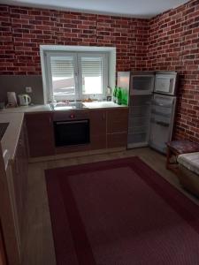 a kitchen with a brick wall at Apartman Duman in Livno