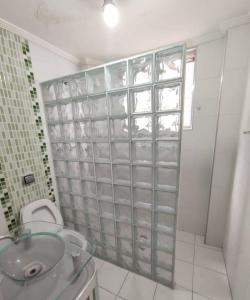 a bathroom with a sink and a toilet and a shower at Lar de férias in São Vicente