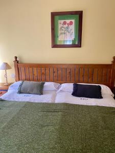 a bedroom with a large bed with two pillows at Aparthotel Es de Don Joan in Unha