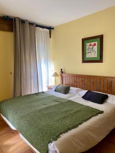 a large bed in a bedroom with a window at Aparthotel Es de Don Joan in Unha