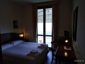 Posteľ alebo postele v izbe v ubytovaní Hotel Belvedere