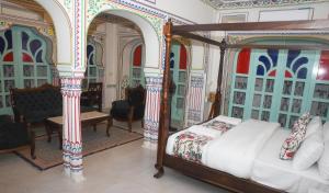 a bedroom with a bed in a room with ornate walls at KothiPushkar in Pushkar