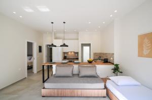 a kitchen and living room with a table and a couch at Borgo Nuovo in Rhodes Town