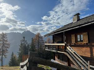 a log cabin with a balcony on the side of it at Kilge Alm in Großkirchheim