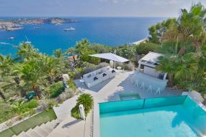 an aerial view of a house with a swimming pool and the ocean at Irresistible Ibiza Villa 3 Bedrooms Villa Buena Private Heated Pool & Underfloor Heating San Jose in Sant Josep de sa Talaia