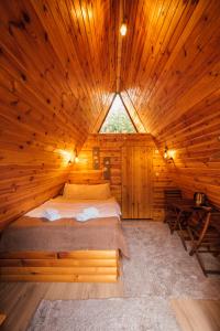 een bed in een houten hut met een raam bij Sapanca Sahil Bungalow in Sapanca