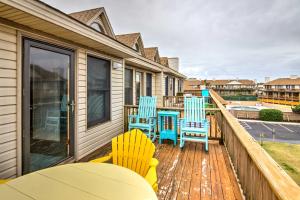 a deck with chairs and tables on a house at Kitty Hawk Townhome at Sea Dunes - Walk to Beach! in Kitty Hawk