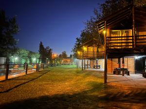 a park at night with a fence and a building at Cabañas Los Troncos in San Pedro +27 photos